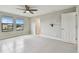 Bedroom featuring light gray tile flooring, two windows, and ceiling fan at 13311 Dorado Shores Ave, Riverview, FL 33579