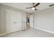 Clean, minimalist bedroom with ceiling fan, tiled floors, and closet at 13311 Dorado Shores Ave, Riverview, FL 33579