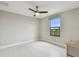 Bright bedroom featuring tiled floors, a ceiling fan, and a large window at 13311 Dorado Shores Ave, Riverview, FL 33579