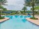 Inviting community pool with comfortable lounge seating and lush palm trees for a relaxing atmosphere at 13311 Dorado Shores Ave, Riverview, FL 33579