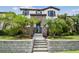 Inviting home featuring stone accents, beautiful landscaping with palm trees and an elevated stone staircase at 13311 Dorado Shores Ave, Riverview, FL 33579