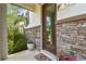 Inviting entryway features a glass-paneled door, stone accents, and potted plants, enhancing curb appeal at 13311 Dorado Shores Ave, Riverview, FL 33579