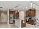 Modern kitchen featuring stainless steel appliances, granite countertops, and stylish pendant lighting at 13311 Dorado Shores Ave, Riverview, FL 33579