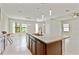 Open concept kitchen with granite counters, stainless steel appliances and modern pendant lighting at 13311 Dorado Shores Ave, Riverview, FL 33579