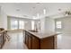 Open concept kitchen with granite counters, stainless steel appliances and modern pendant lighting at 13311 Dorado Shores Ave, Riverview, FL 33579