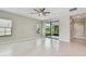 Bright living area features tile flooring, a ceiling fan, and access to a screened-in patio with outdoor views at 13311 Dorado Shores Ave, Riverview, FL 33579