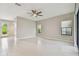 Bright living room featuring tile flooring, a ceiling fan, and natural light from multiple windows at 13311 Dorado Shores Ave, Riverview, FL 33579