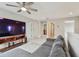 Spacious living room featuring sectional sofa, TV, and natural lighting at 13311 Dorado Shores Ave, Riverview, FL 33579