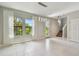 Bright living room featuring neutral walls, large windows, and tiled floor at 13311 Dorado Shores Ave, Riverview, FL 33579
