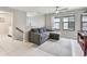 Comfortable living room featuring a cozy gray sofa, white tile floors, and a modern ceiling fan at 13311 Dorado Shores Ave, Riverview, FL 33579