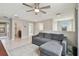 Comfortable living area featuring a sectional sofa, ceiling fan, and open doorway at 13311 Dorado Shores Ave, Riverview, FL 33579