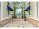 Charming entrance to the community pool with brick paving, palm trees, and covered walkways at 13311 Dorado Shores Ave, Riverview, FL 33579