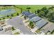 Aerial view of homes showing the neighborhood layout and a nearby pond, with lush greenery at 13814 Harvestwood Ln, Riverview, FL 33569