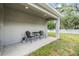Back patio featuring chairs and a small table, perfect for enjoying a drink or entertaining at 13814 Harvestwood Ln, Riverview, FL 33569