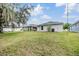 A wide shot of the backyard showing ample space, a well-maintained lawn, and views of the home's exterior at 13814 Harvestwood Ln, Riverview, FL 33569
