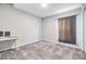 Simple bedroom design with a clean desk space, carpeted floors, and a curtained window at 13814 Harvestwood Ln, Riverview, FL 33569