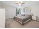 Well-lit bedroom featuring a ceiling fan, neutral walls, carpet, and a window offering natural light at 13814 Harvestwood Ln, Riverview, FL 33569