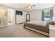 Spacious bedroom with plush carpeting, a large window, and an ensuite bathroom entry at 13814 Harvestwood Ln, Riverview, FL 33569