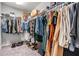 Walk-in closet with ample hanging space and shoe racks at 13814 Harvestwood Ln, Riverview, FL 33569