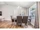 The dining area has a wooden table with six chairs and a window view to the outside at 13814 Harvestwood Ln, Riverview, FL 33569