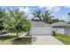 The house is front-facing with a two-car garage, a tidy lawn, and is situated in a well-kept neighborhood at 13814 Harvestwood Ln, Riverview, FL 33569