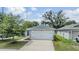 The house is front-facing with a two-car garage, a tidy lawn, and is situated in a well-kept neighborhood at 13814 Harvestwood Ln, Riverview, FL 33569