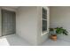 The front porch has a grey front door, a window, and a green plant at 13814 Harvestwood Ln, Riverview, FL 33569