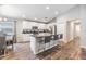 Well-lit kitchen with a kitchen island, bar seating, and stainless steel appliances; dining area visible at 13814 Harvestwood Ln, Riverview, FL 33569