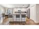 Open-concept kitchen with island bar seating, stainless steel appliances, and adjacent dining area at 13814 Harvestwood Ln, Riverview, FL 33569