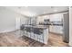 Stylish kitchen with an island featuring bar stools, stainless steel appliances, and an open layout at 13814 Harvestwood Ln, Riverview, FL 33569