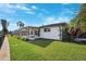 Lush backyard featuring a screened-in porch, perfect for outdoor relaxation and entertainment at 1399 49Th Ne Ave, St Petersburg, FL 33703
