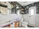 Unique bathroom featuring patterned wallpaper, marble walls, and modern fixtures ready for renovation at 1399 49Th Ne Ave, St Petersburg, FL 33703