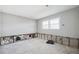 Bedroom featuring a window, smooth gray walls, and exposed studs, awaiting renovation at 1399 49Th Ne Ave, St Petersburg, FL 33703