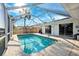 Relaxing screened-in pool with views of the canal and surrounding greenery at 1399 49Th Ne Ave, St Petersburg, FL 33703