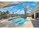 Gorgeous screened-in pool with a canal view and lush greenery at 1399 49Th Ne Ave, St Petersburg, FL 33703