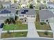 Aerial view of a two-story home with solar panels, a two-car garage, and mature landscaping at 14135 Arbor Pines Dr, Riverview, FL 33579