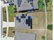 A high aerial view showcases a home featuring solar panels and a fenced backyard at 14135 Arbor Pines Dr, Riverview, FL 33579