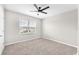 Neutral bedroom with carpet, a ceiling fan, and a view of neighborhood homes at 14135 Arbor Pines Dr, Riverview, FL 33579