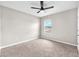 Cozy bedroom with neutral carpet, a ceiling fan, and a bright window at 14135 Arbor Pines Dr, Riverview, FL 33579