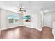 Spacious bedroom featuring wood floors, a ceiling fan, and a view from the window at 14135 Arbor Pines Dr, Riverview, FL 33579