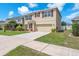 Charming home with a two-car garage, complemented by lush green grass and well-kept landscaping at 14135 Arbor Pines Dr, Riverview, FL 33579