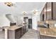 Open kitchen featuring tile floors, granite countertops, updated appliances, and a center island at 14135 Arbor Pines Dr, Riverview, FL 33579