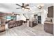Open-concept living room and kitchen, with updated appliances, tile flooring, and wood accent wall at 14135 Arbor Pines Dr, Riverview, FL 33579