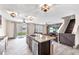 Open concept room featuring tile floors, a modern kitchen, staircase, and sliding glass doors to the backyard at 14135 Arbor Pines Dr, Riverview, FL 33579