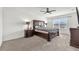 Comfortable main bedroom with a large bed, ceiling fan, and window providing natural light at 14135 Arbor Pines Dr, Riverview, FL 33579