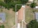 Aerial view of the property highlighting its roof, surrounding landscape, and overall lot layout at 14312 1St St, Dade City, FL 33525