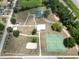 Bird's-eye view of community park showcasing basketball courts, playground, and green spaces for recreation and leisure at 14312 1St St, Dade City, FL 33525