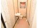Simple bathroom with basic amenities, including toilet, sink, and minimal storage for functionality at 14312 1St St, Dade City, FL 33525