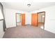 Spacious bedroom boasts neutral carpet, fresh paint, and multiple doors at 14312 1St St, Dade City, FL 33525