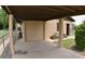 Covered carport providing shelter for vehicles, along with a fenced yard and tidy landscaping at 14312 1St St, Dade City, FL 33525
